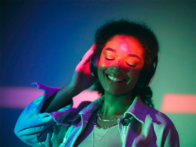 girl smiling wearing noise-cancelling headphones