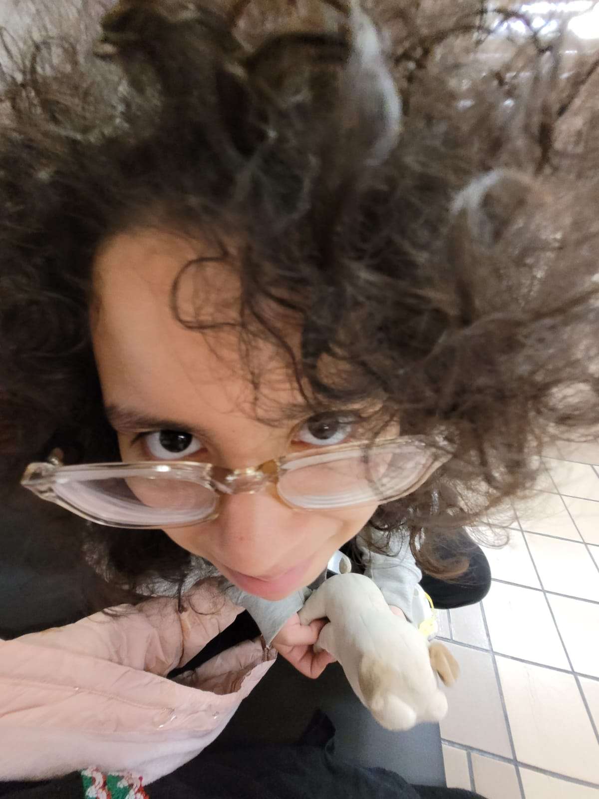 a photo of me holding a puppy plush in a 0.5 lense