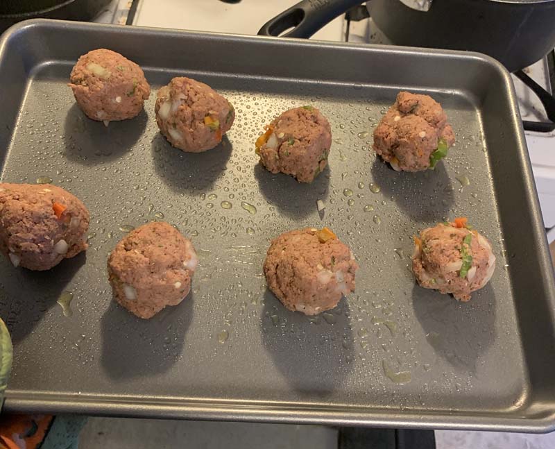 photo of meatballs on a baking sheet before cooking