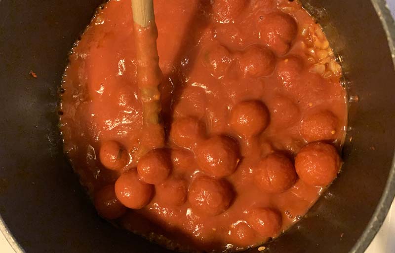 a pot of meatballs covered in sauce