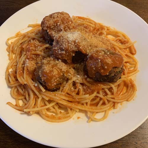 a plate with spaghetti, meatballs, and sauce