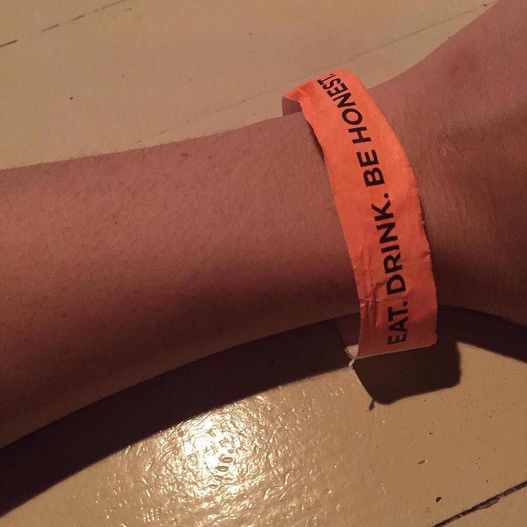 photo of my arm and i've got a show wristband that says 'eat. drink. be honest.'