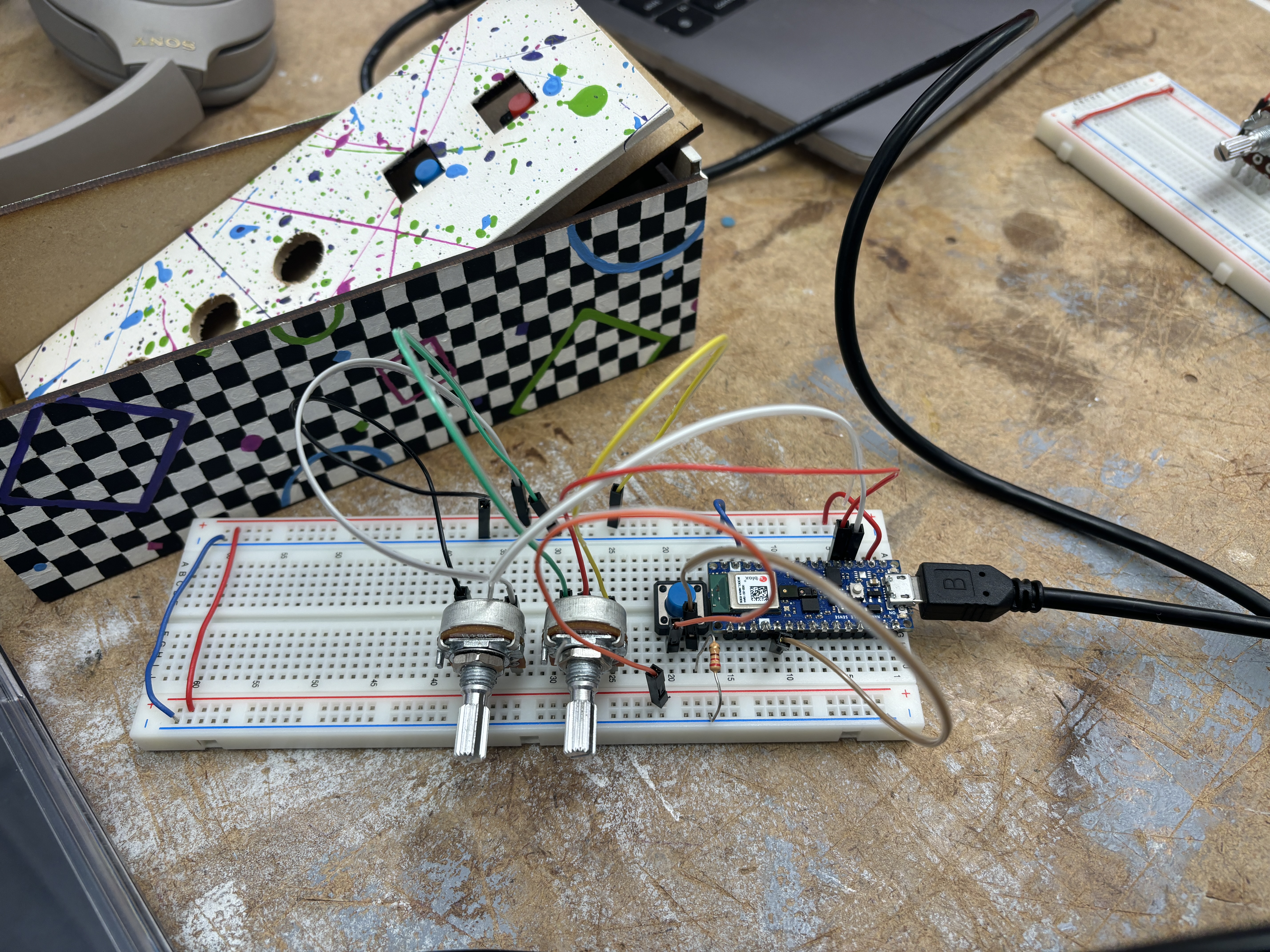breadboard with two potentiometers and a button