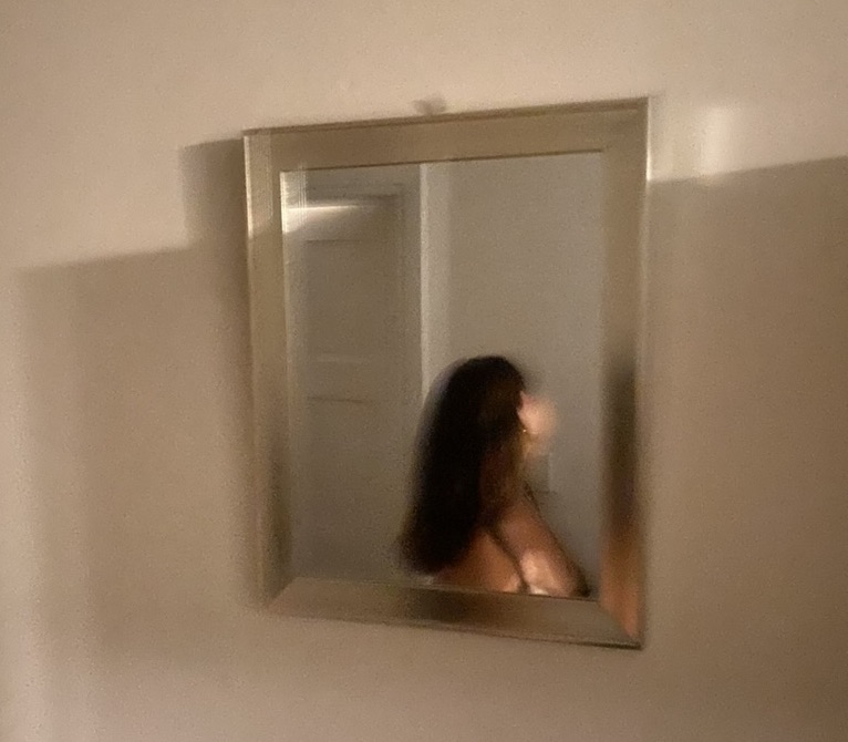image of Olivia reflected in mirror